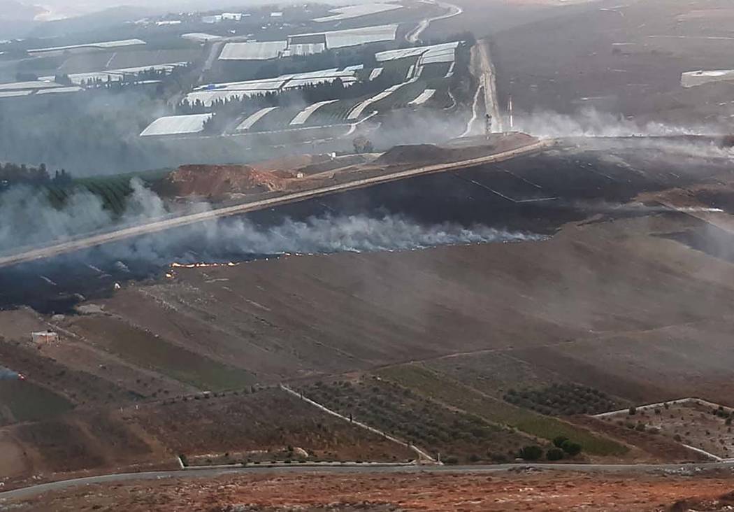 Smoke rises from Israeli army shells that landed in the southern Lebanese border village of Mar ...