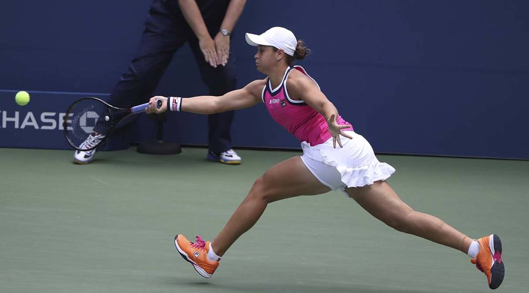 Ashleigh Barty, of Australia, stretches for a return against Qiang Wang, of China, during round ...