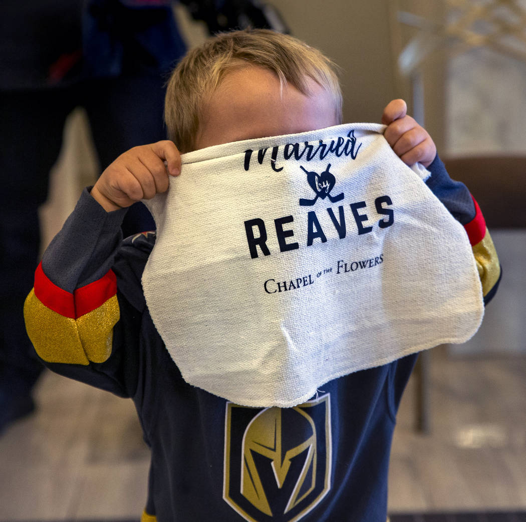 J.J. Long, 2, holds a ceremonial battle towel over his face as Vegas Golden Knights player Ryan ...