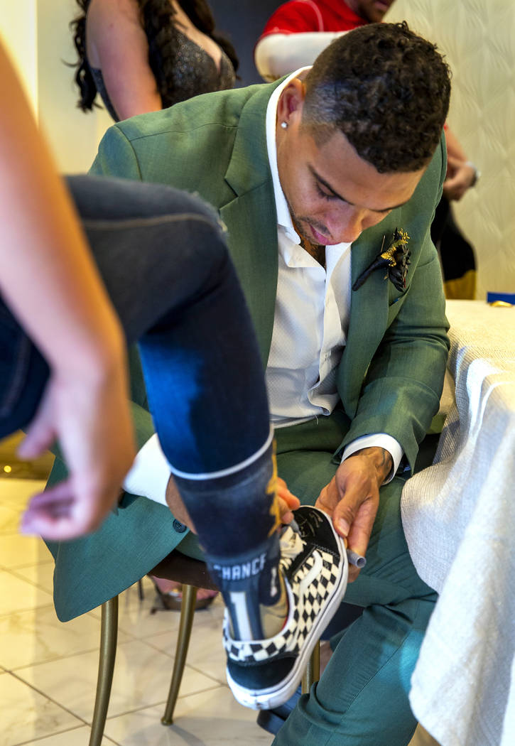 Vegas Golden Knights player Ryan Reaves autographs a sneaker for a guest after conducting a mar ...