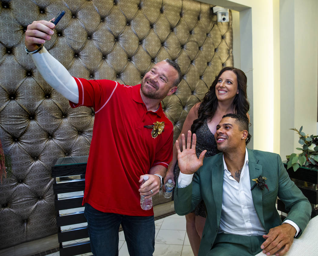 (From left) Justin and Laura Long join Vegas Golden Knights player Ryan Reaves in a quick messa ...