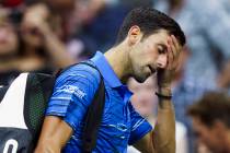 Novak Djokovic, of Serbia, walks off the court as he retires during his match against Stan Wawr ...