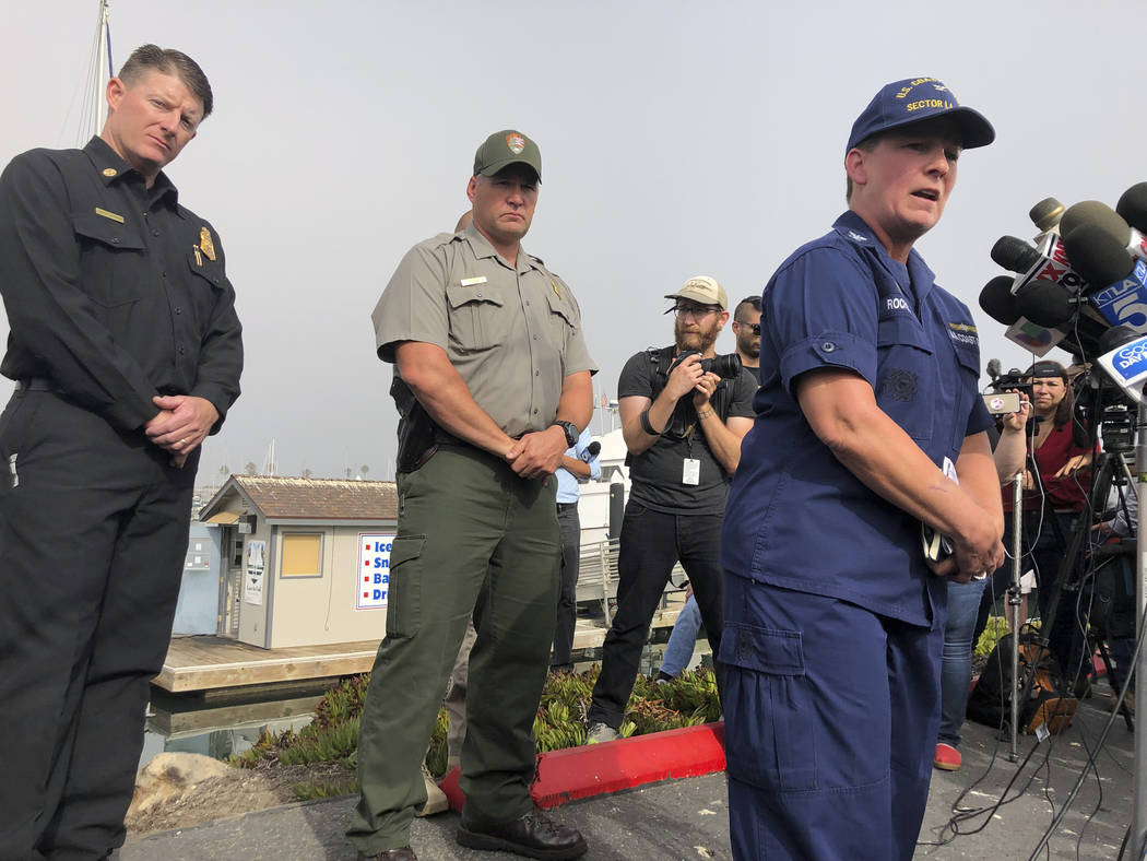 Coast Guard Capt. Monica Rochester, right, addresses the media at the U.S. Coast Guard Station ...