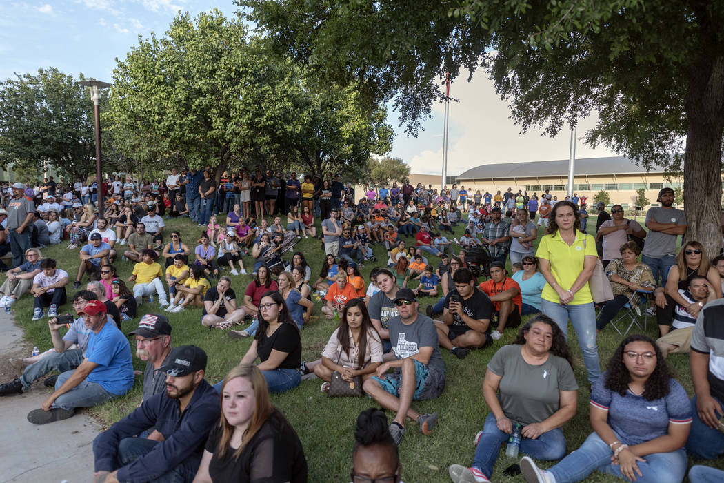 People attend a vigil for victims of a shooting spree the day before, Sunday, Sept. 1, 2019, at ...