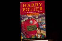 This May 20, 2013, file photo shows a first edition copy of the first Harry Potter book "Harry ...