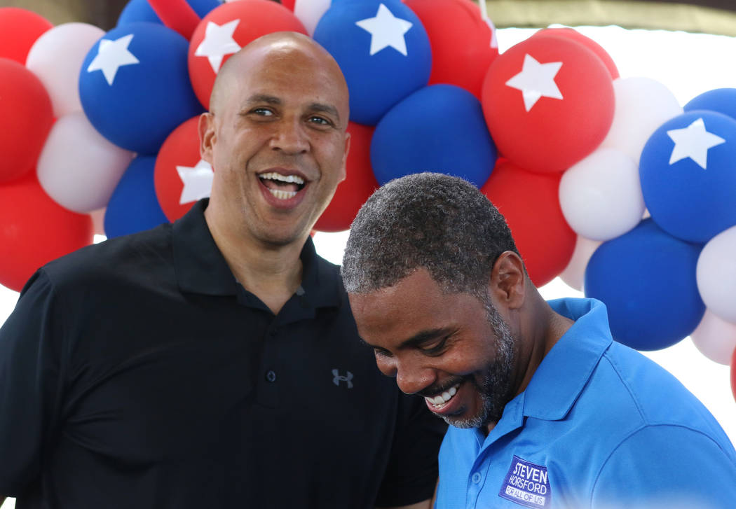 Democratic presidential candidate Sen. Cory Booker, D-N.J., left, shares a laugh after being in ...