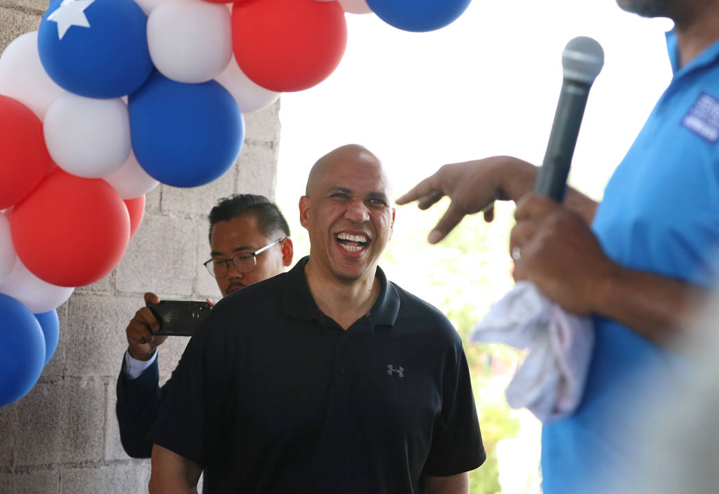 Democratic presidential candidate Sen. Cory Booker, D-N.J., left, smiles as he is introduced by ...