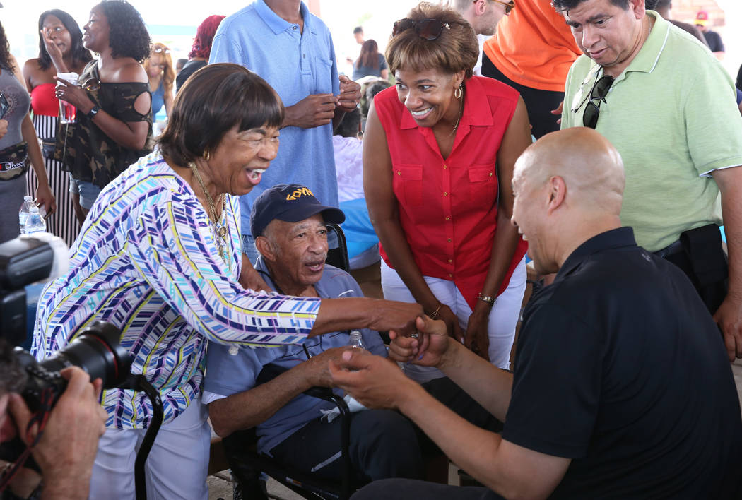 Democratic presidential candidate Sen. Cory Booker, D-N.J., right, greet Naomi Goynes, left, as ...