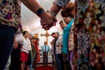 Members of the congregation at Elkmont United Methodist Church hold hands at the conclusion of ...