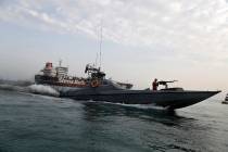 In a July 21, 2019, file photo, a speedboat of the Iran's Revolutionary Guard moves around a Br ...