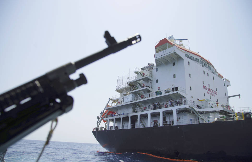 A June 19, 2019, file photo, shows sailors standing on deck above a hole the U.S. Navy says was ...