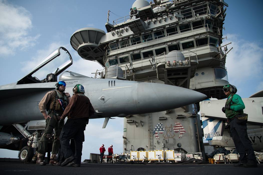 In a June 3, 2019, file photo, a pilot speaks to a crew member by an F/A-18 fighter jet on the ...