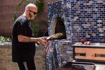 John Courtney, chef of Block 16 at The Cosmopolitan of Las Vegas hotel-casino, pulls out a red ...