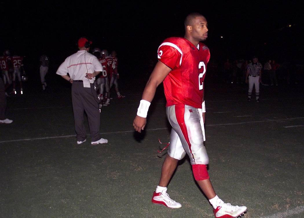 UNLV quarterback Jason Thomas walks off the field in a darkened Sam Boyd Stadium after the Rebe ...