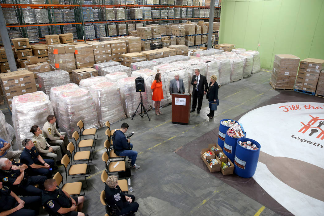 Three Square Food Bank Chief Development Officer Michelle Beck, from left, Boulder City Mayor K ...