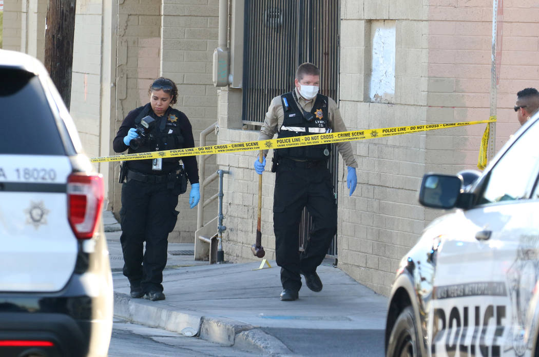 Las Vegas police collect evidence after a woman was killed with a sledgehammer on the 1000 bloc ...