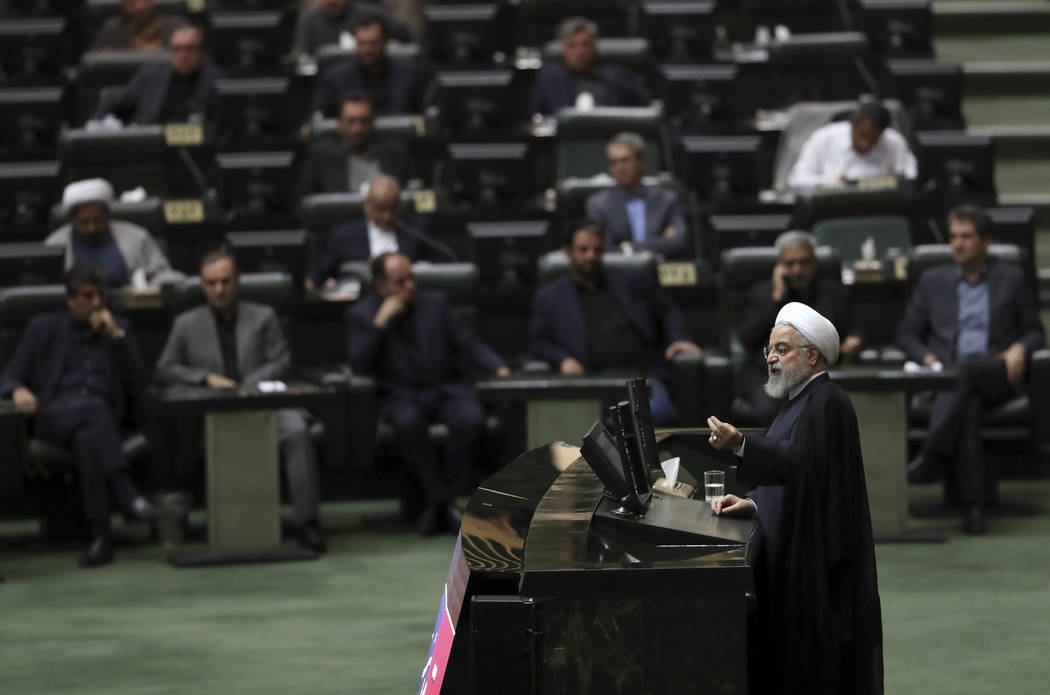 Iranian President Hassan Rouhani speaks at a session of parliament to debate his proposed touri ...