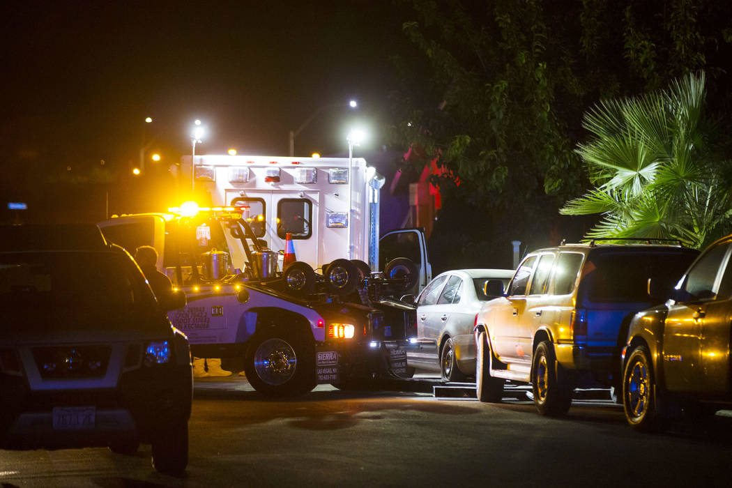 A tow truck prepares to move a vehicle blocking a driveway as Las Vegas police search a Spring ...