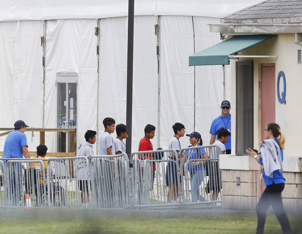 FILE - In this June 20, 2018 photo, immigrant children walk in a line outside the Homestead Tem ...