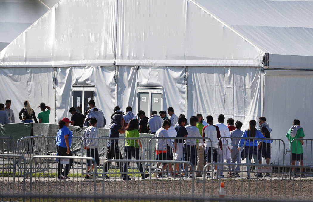 FILE- In this Feb. 19, 2019 file photo, children line up to enter a tent at the Homestead Tempo ...