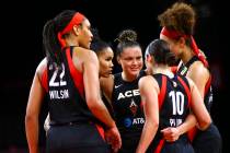 Las Vegas Aces' Kayla McBride, third from left, leads her teammates in a huddle during the seco ...