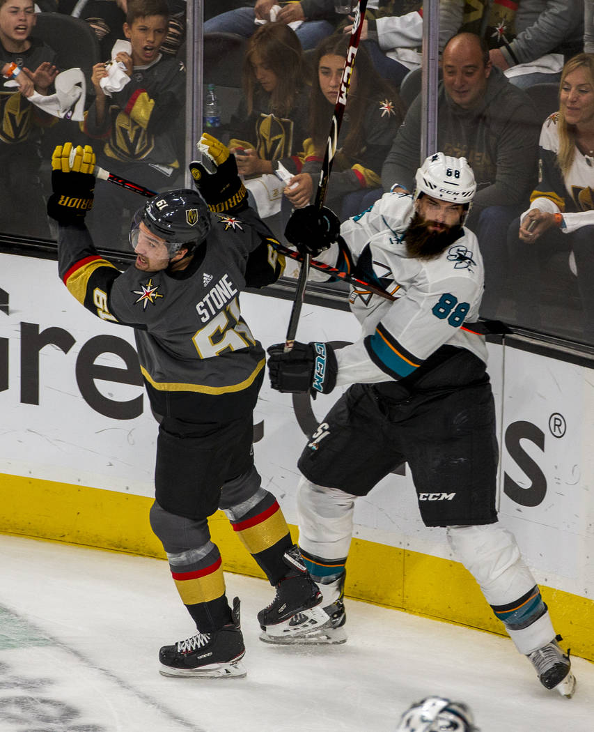 Golden Knights right wing Mark Stone (61) tangles with San Jose Sharks defenseman Brent Burns ( ...