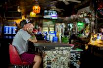 Andrew Parker watches the latest on Hurricane Dorian from the bar at Huc-A-Poos pizza restauran ...