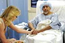 Susan Cervantes, left, comforts husband Agustin Cervantes before he undergoes hernia surgery by ...