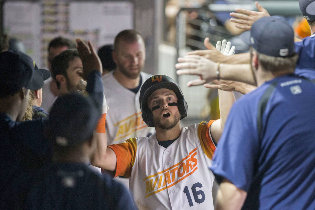 Las Vegas Aviators left fielder Mark Payton (16) celebrates with teammates after Payton hit a h ...