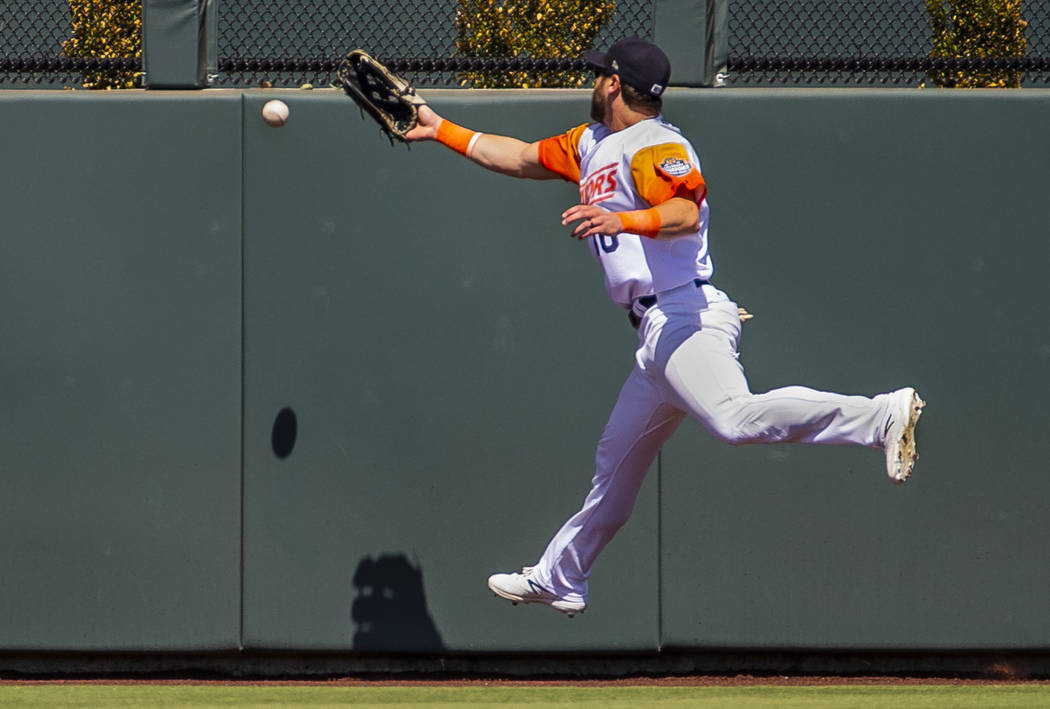 Las Vegas Aviators center fielder Dustin Fowler (10) misses a long ball near the wall in the fo ...