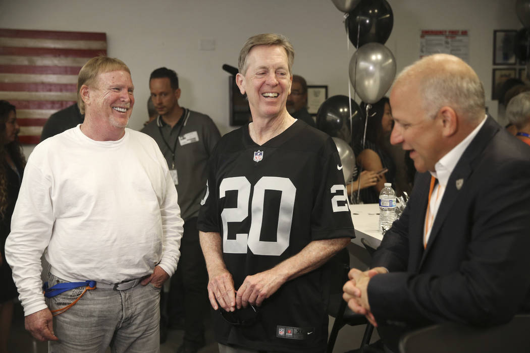 Allegiant Chairman and CEO Maury Gallagher, center, with Raiders' Owner Mark Davis, left, and p ...