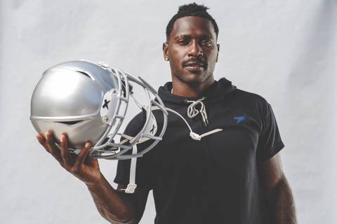 Raiders wide receiver Antonio Brown holds his new helmet, the Shadow by helmet-maker Xenith. Ph ...