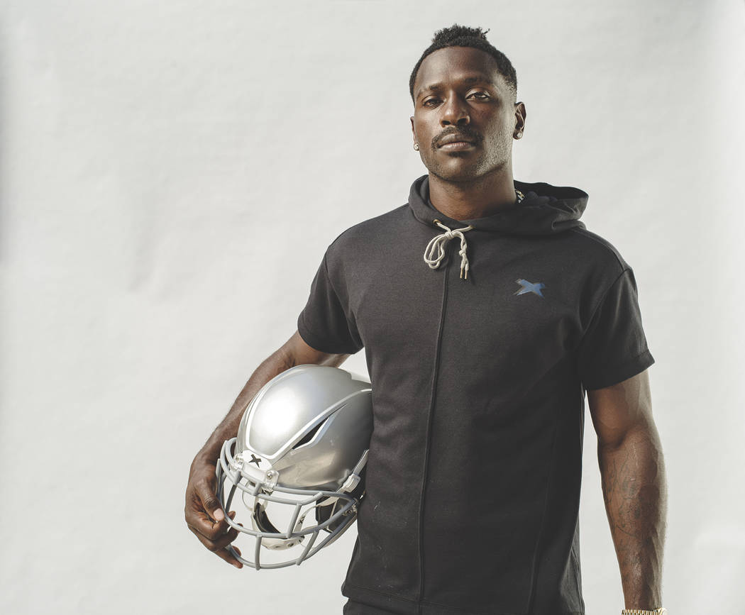 Raiders wide receiver Antonio Brown holds his new helmet, the Shadow by helmet-maker Xenith. Ph ...