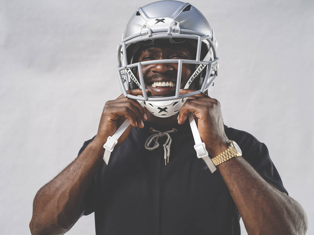 Raiders wide receiver Antonio Brown tries on his new helmet, the Shadow by helmet-maker Xenith. ...