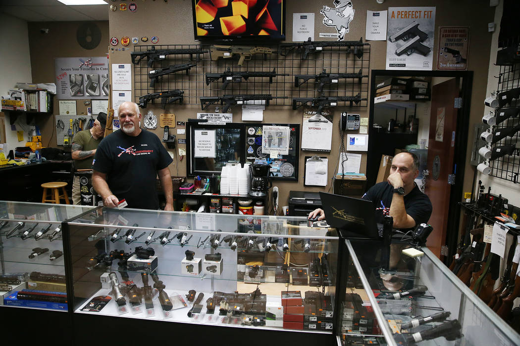 Mark Hames, owner of 2nd Amendment Gun Shop, and store manager Charles Mazza, are interviewed i ...