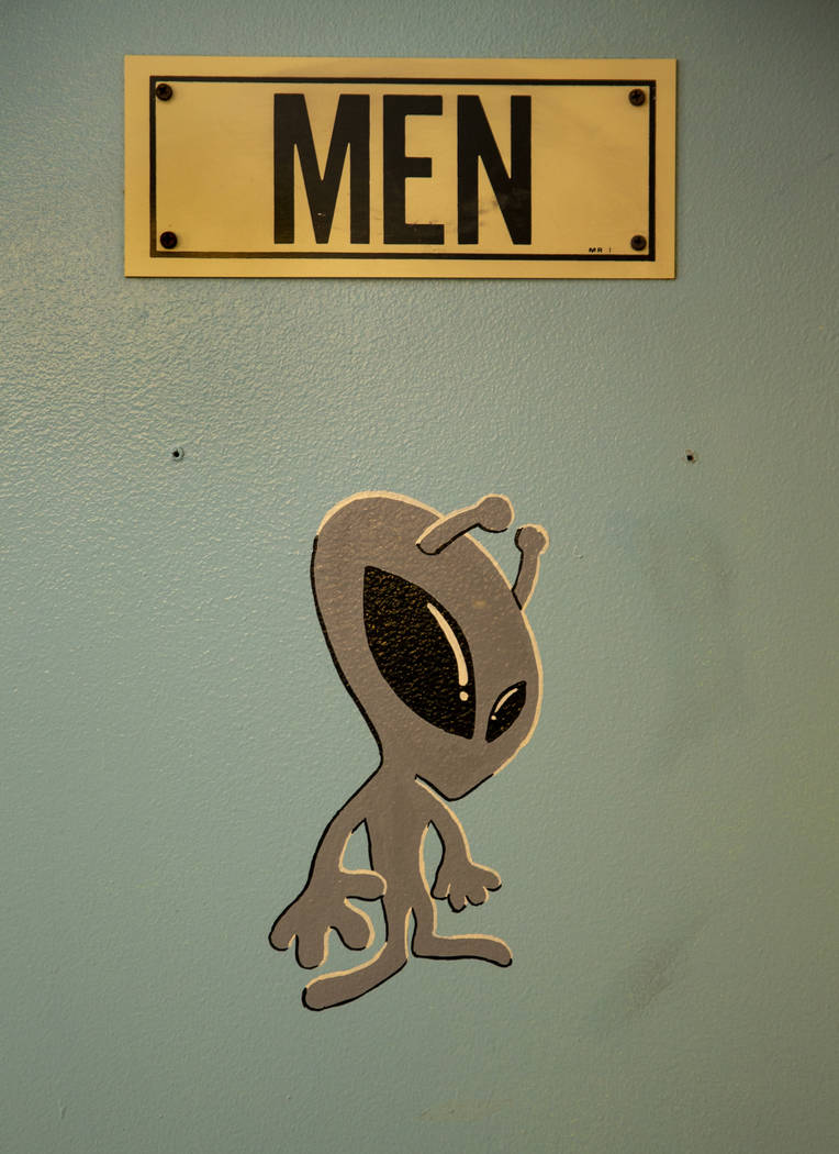 An alien sticker is on the men's bathroom door in the restaurant at the Little A'Le'Inn which i ...