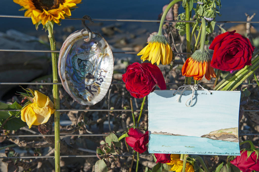 Flowers and handmade art on an abalone shell is displayed at a memorial for the victims of Mond ...