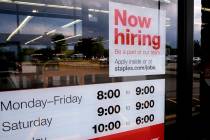 In this Aug. 15, 2019, photo a "Now hiring" sign is displayed on the front door of a Staples st ...