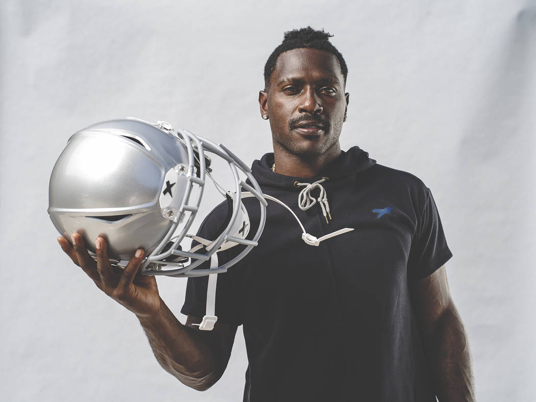 Raiders wide receiver Antonio Brown holds his new helmet, the Shadow by helmet-maker Xenith. (X ...