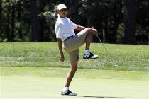 President Barack Obama reacts as he misses a shot while golfing on the first hole at Farm Neck ...