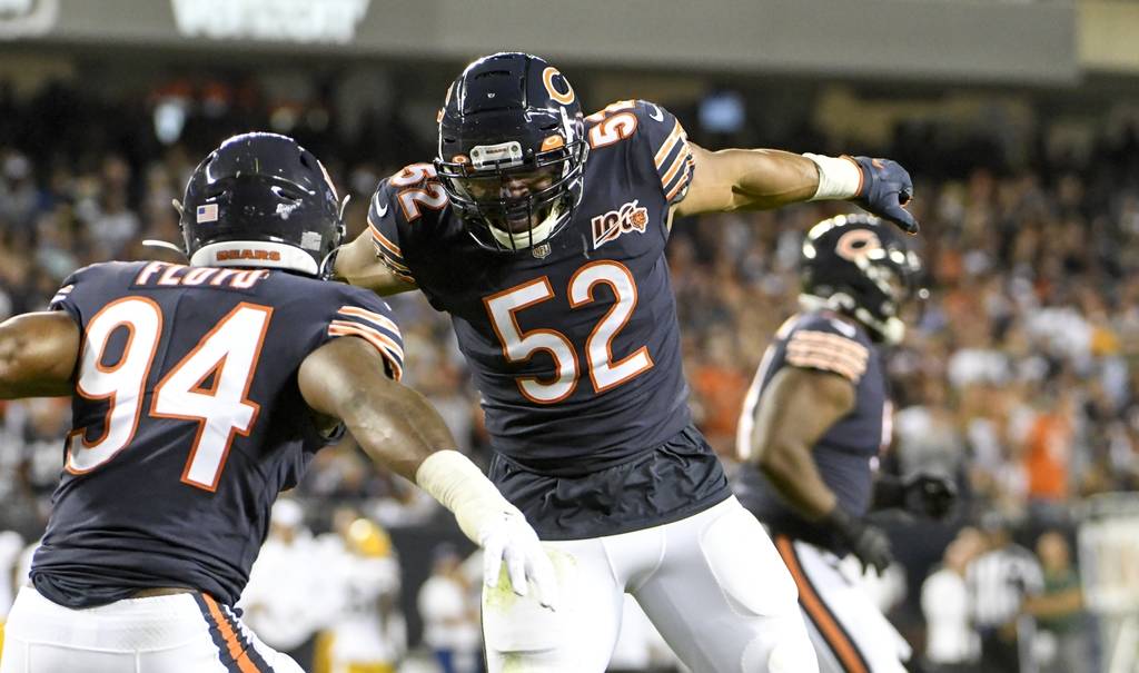 Chicago Bears' Leonard Floyd is congratulated by Khalil Mack after sacking Green Bay Packers' A ...