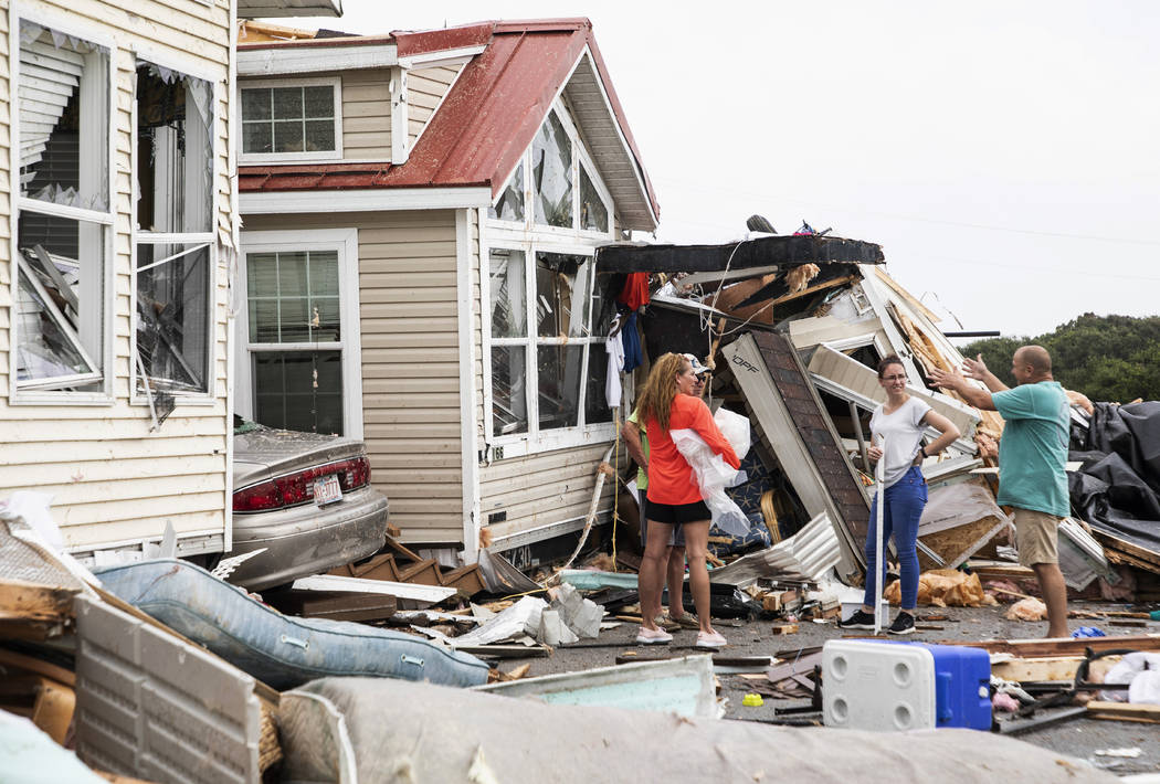 Residents of the Boardwalk RV Park discuss the path of a possible waterspout or tornado, genera ...