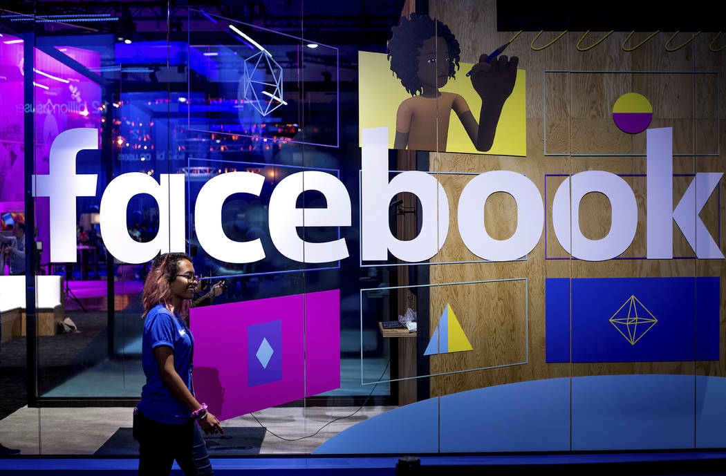 In a Tuesday, April 18, 2017, file photo, a conference worker passes a demo booth at Facebook's ...