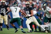 Colorado State safety Jamal Hicks, left, comes in to tackle Colorado quarterback Steven Montez, ...