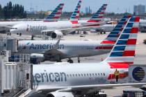 In an April 24, 2019, photo, American Airlines aircraft are shown parked at their gates at Miam ...
