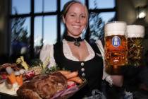Anastasia Danesi holds up beer and food at the Hofbrauhaus on Wednesday, Sept. 23, 2004. (Phot ...
