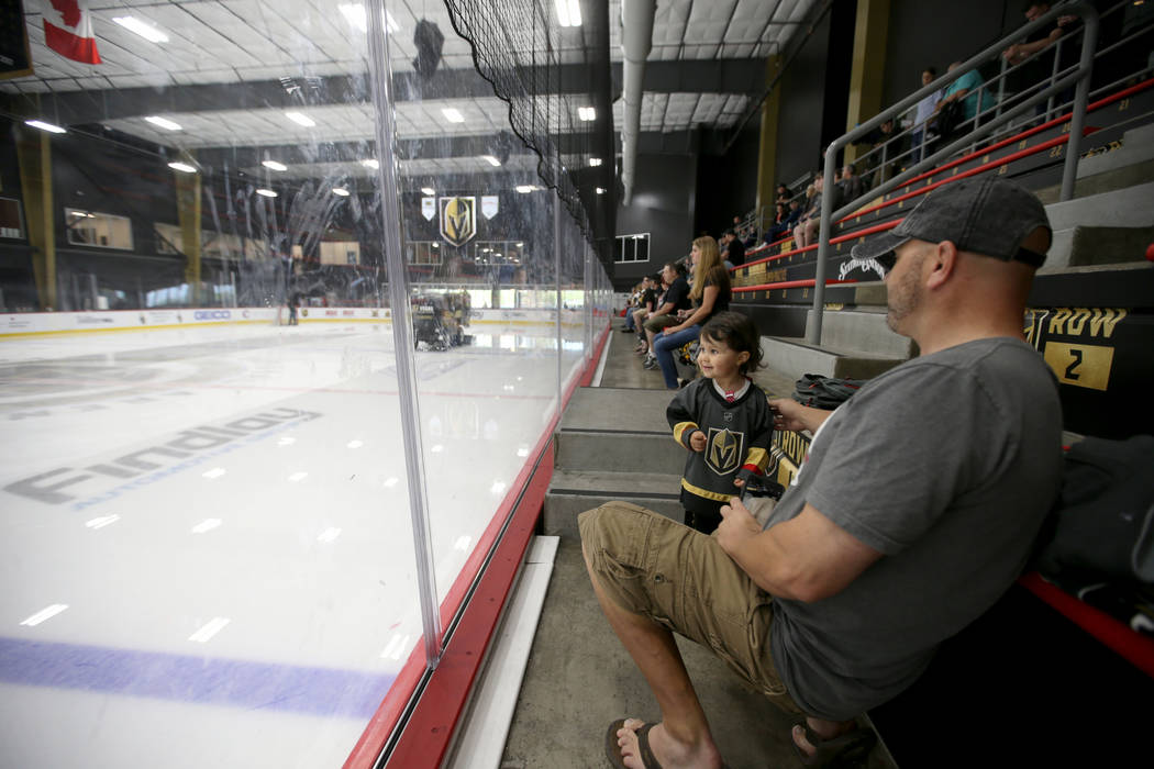 Josh Griffin, 41, and is daughter Madeleine, 2, watch the Zamboni during the Vegas Golden Knigh ...