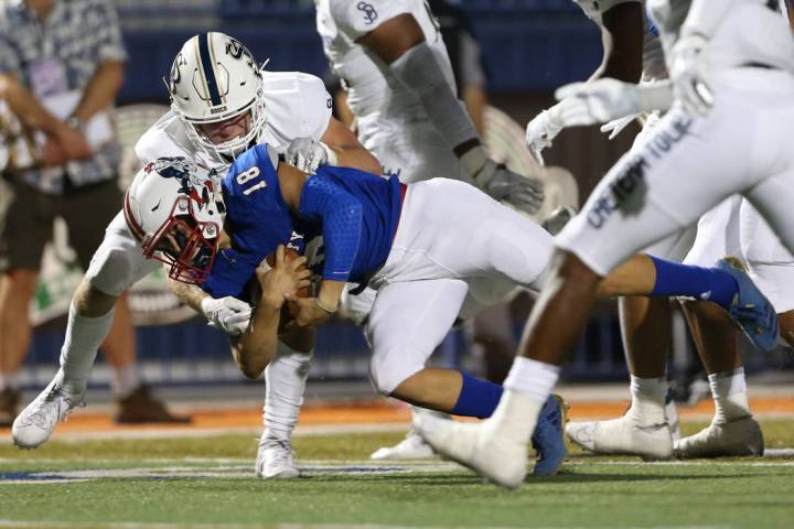 Lberty's Daniel Britt (18) is tackled by St. John Bosco's Jake Newman (7) during the first quar ...