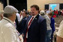 Nevada state GOP chairman Michael McDonald speaks to party delegates standing on line to vote f ...