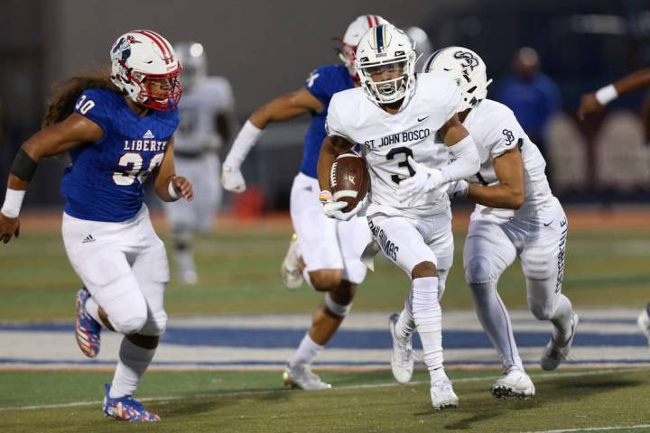 St. John Bosco's Jode McDuffie (3) runs the ball for a touchdown under pressure from Liberty's ...